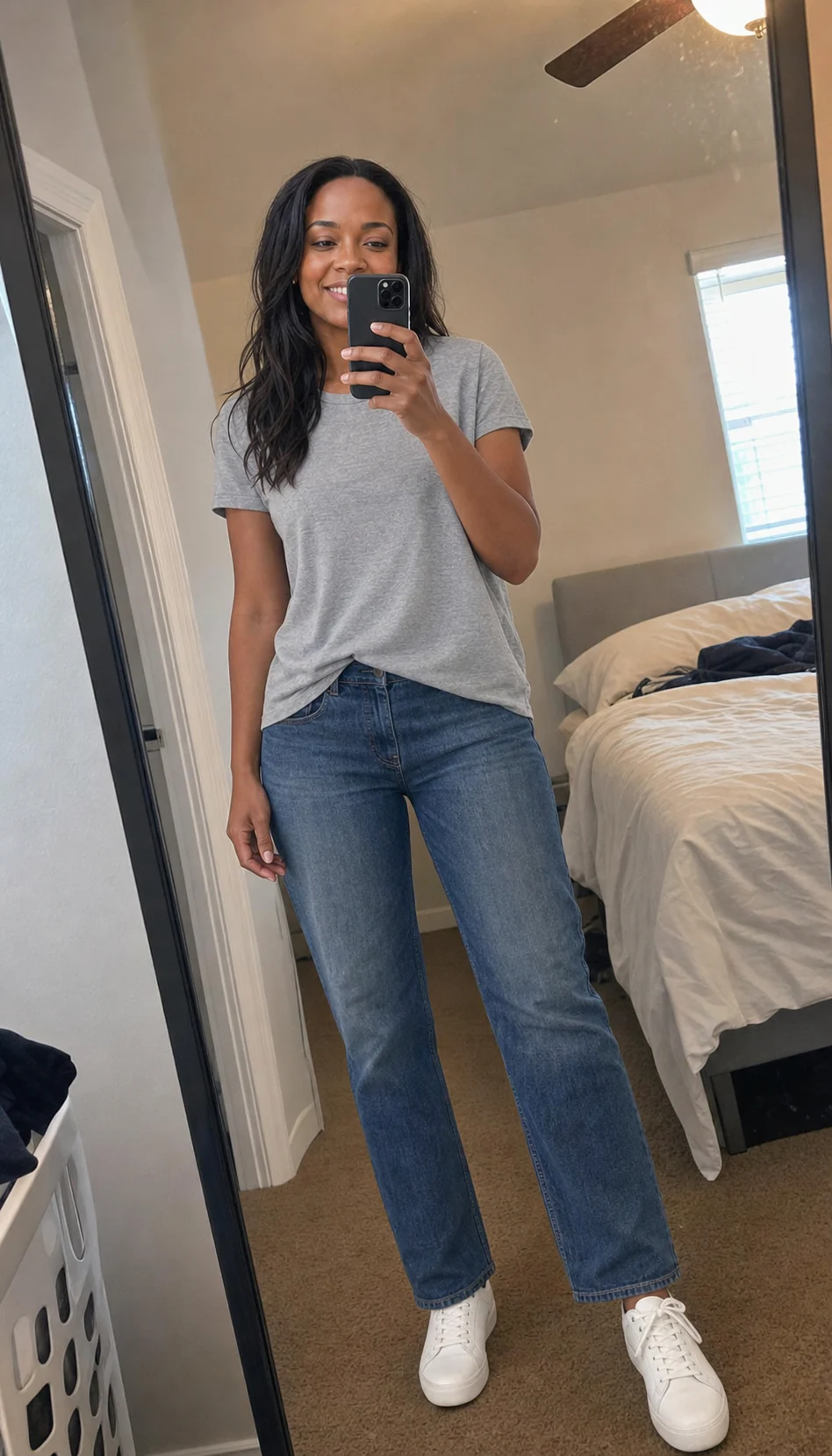 Maya taking an ordinary full-length mirror selfie at home